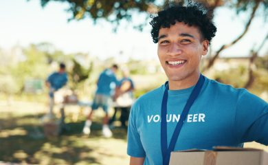 Man, excited and portrait of volunteer in nature with community service, NGO or donation project. Happy, confident and face of male charity worker with confidence outdoor in field for social activism.